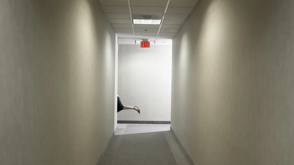 Lead illustration for article, showing a person disappearing down a corridor to the exit.